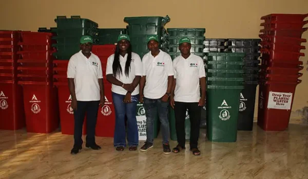 Some members of FEP Committee led by Professor Robert Onyeneke posing in front of the bins