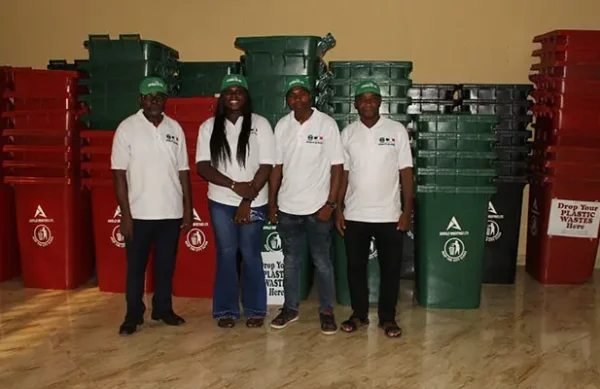 Some members of FEP Committee led by Professor Robert Onyeneke posing in front of the bins